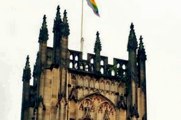 Pride flag flying above Manchester Cathedral